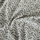 Togo Black & Natural fabric, a charcoal grey and oatmeal beige botanical print fabric from Tonic Living