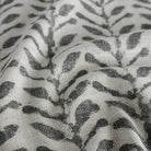 a charcoal gray and oatmeal beige botanical print fabric : close up view