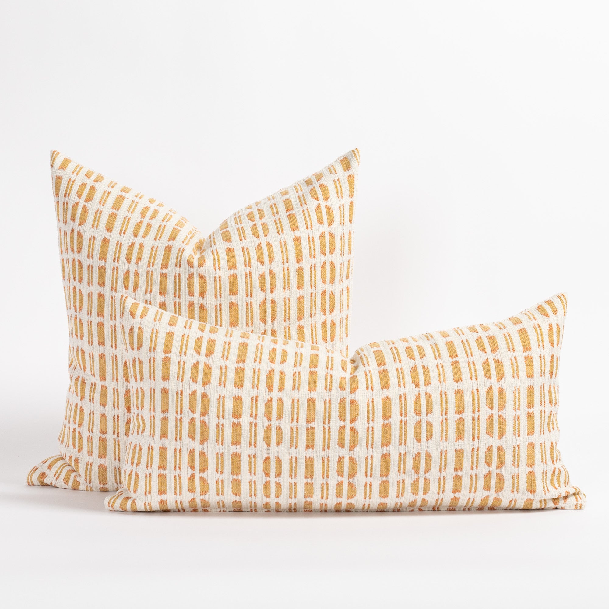 Calima Sunglow yellow, tangerine and white ikat patterned square and lumbar pillows