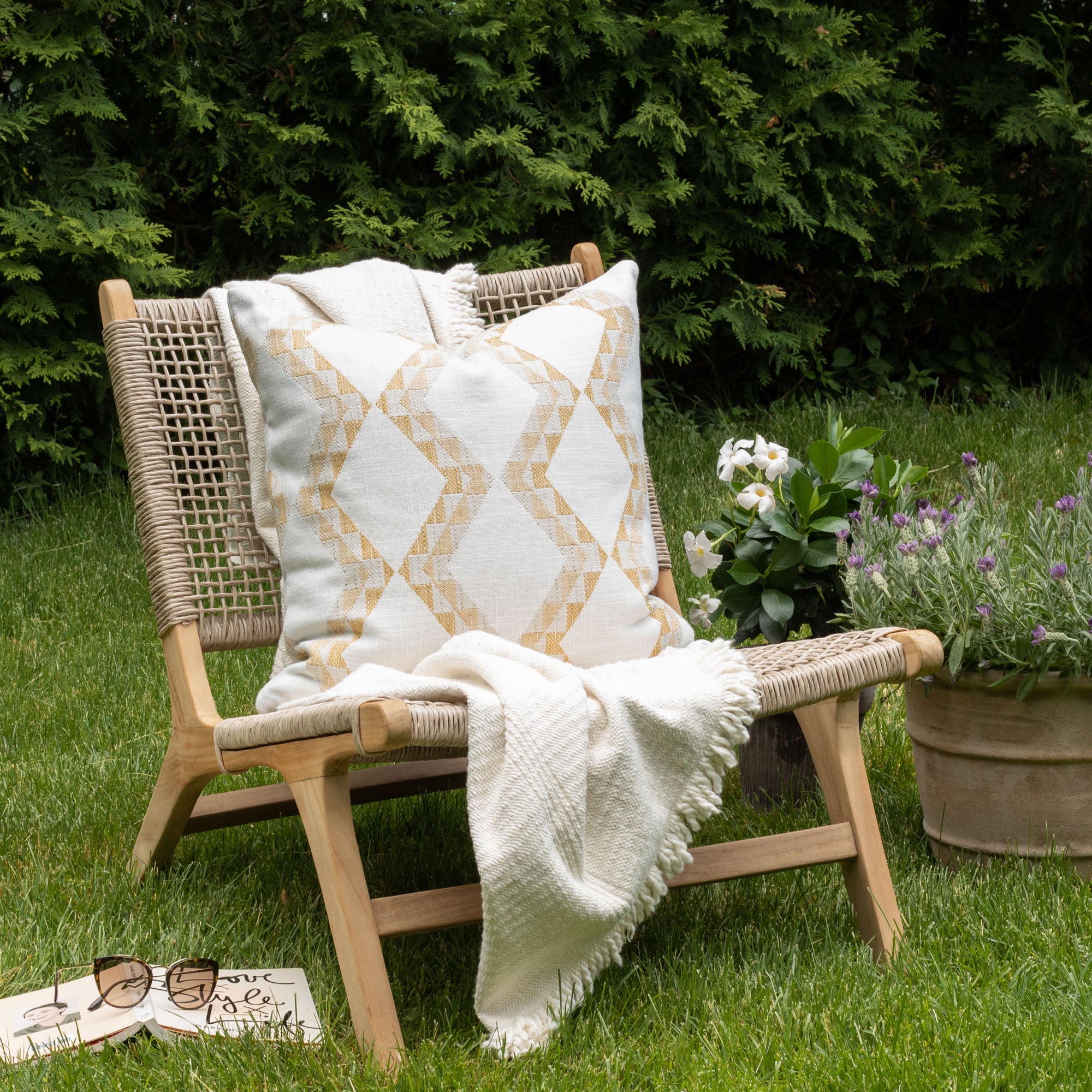 Outdoor vignette :  modern graphic patterned white and yellow outdoor pillow from Tonic Living in gold hues